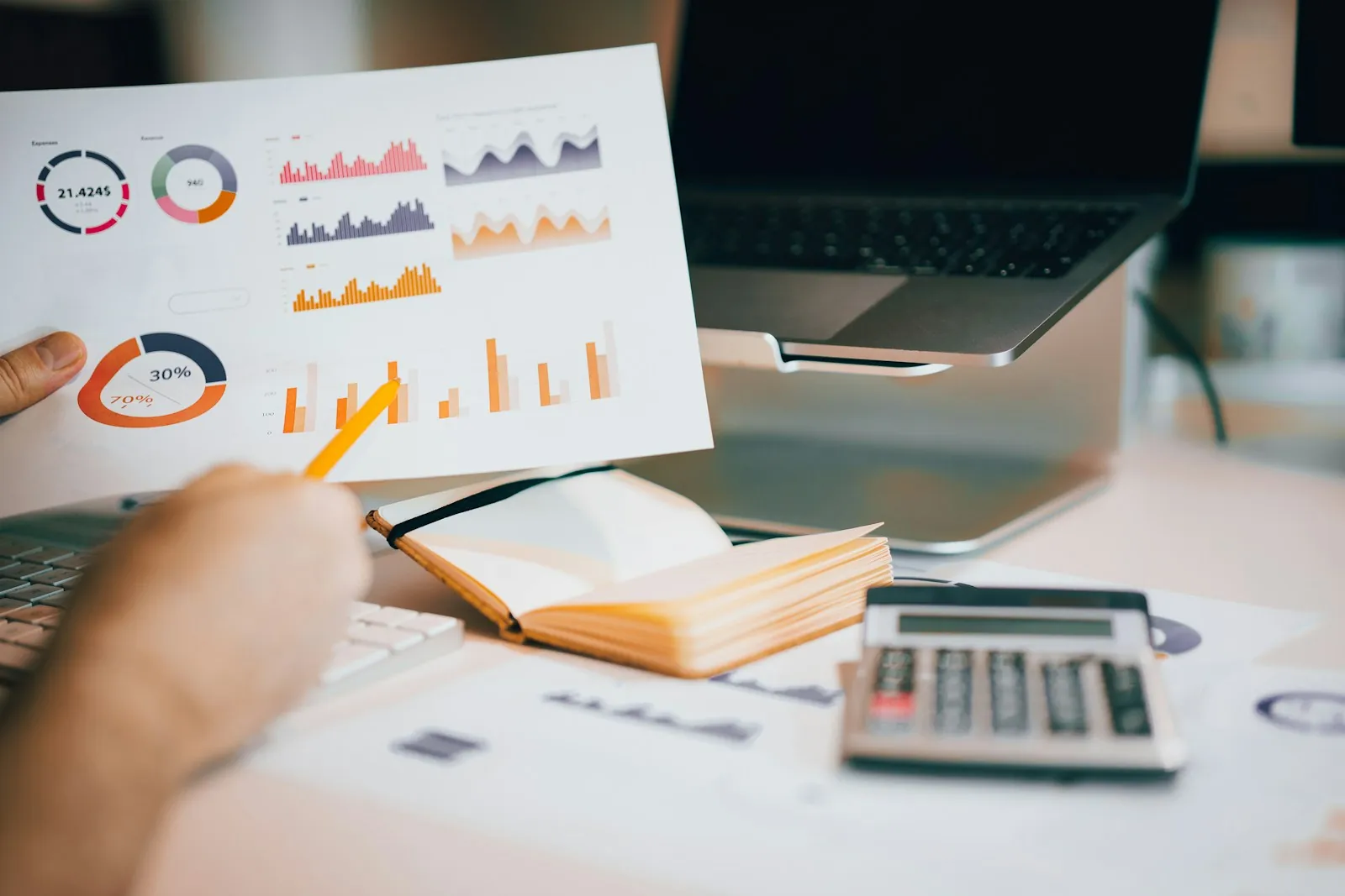 Financial charts and reports reviewed at a desk