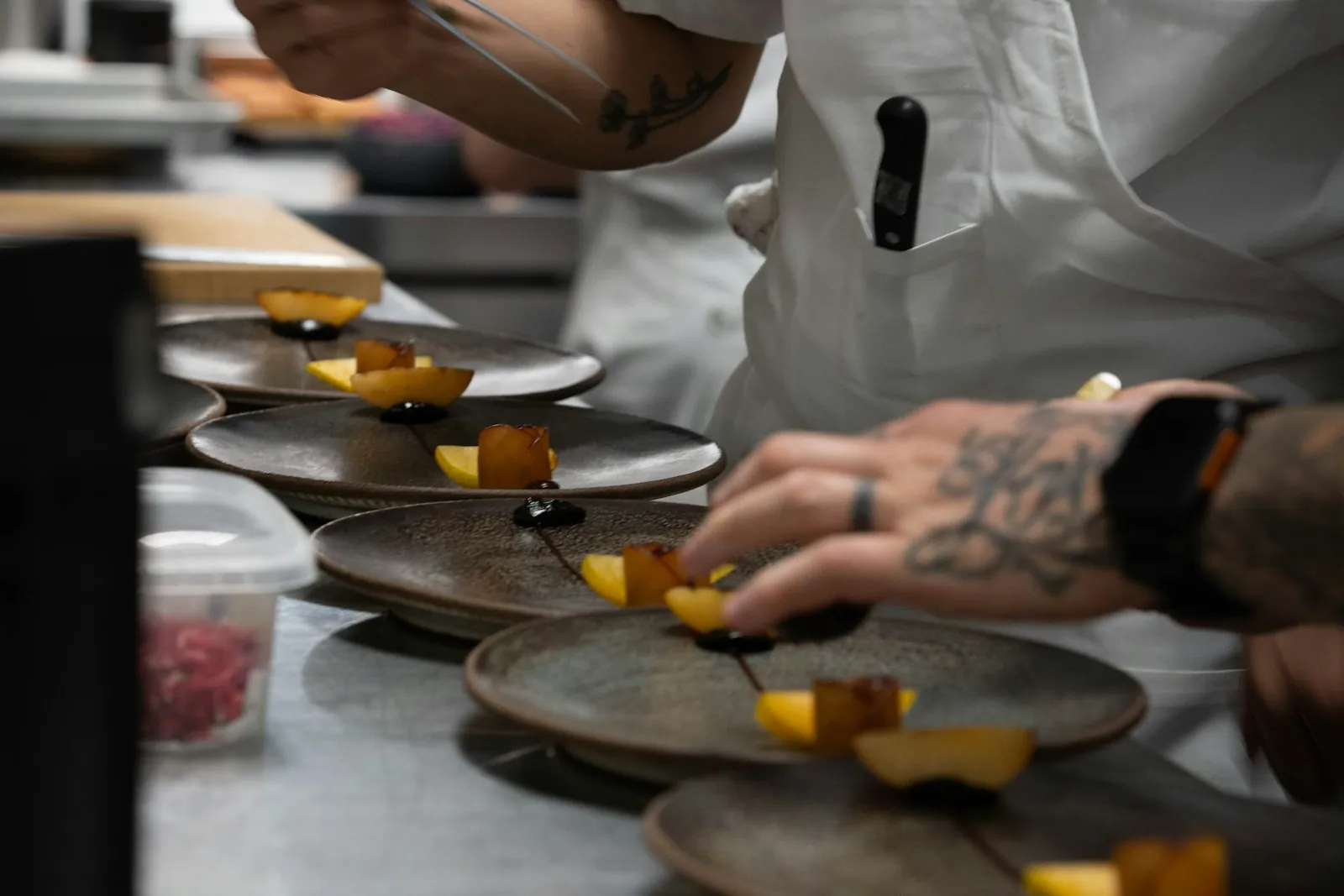 Chefs plating dishes during service